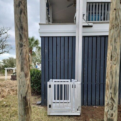 Galaxy Shuttle cargo lift installed against dark navy siding