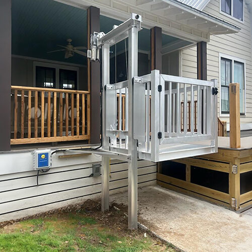 Galaxy Shuttle+ cargo lift on a gray home with a tin roof and covered porch