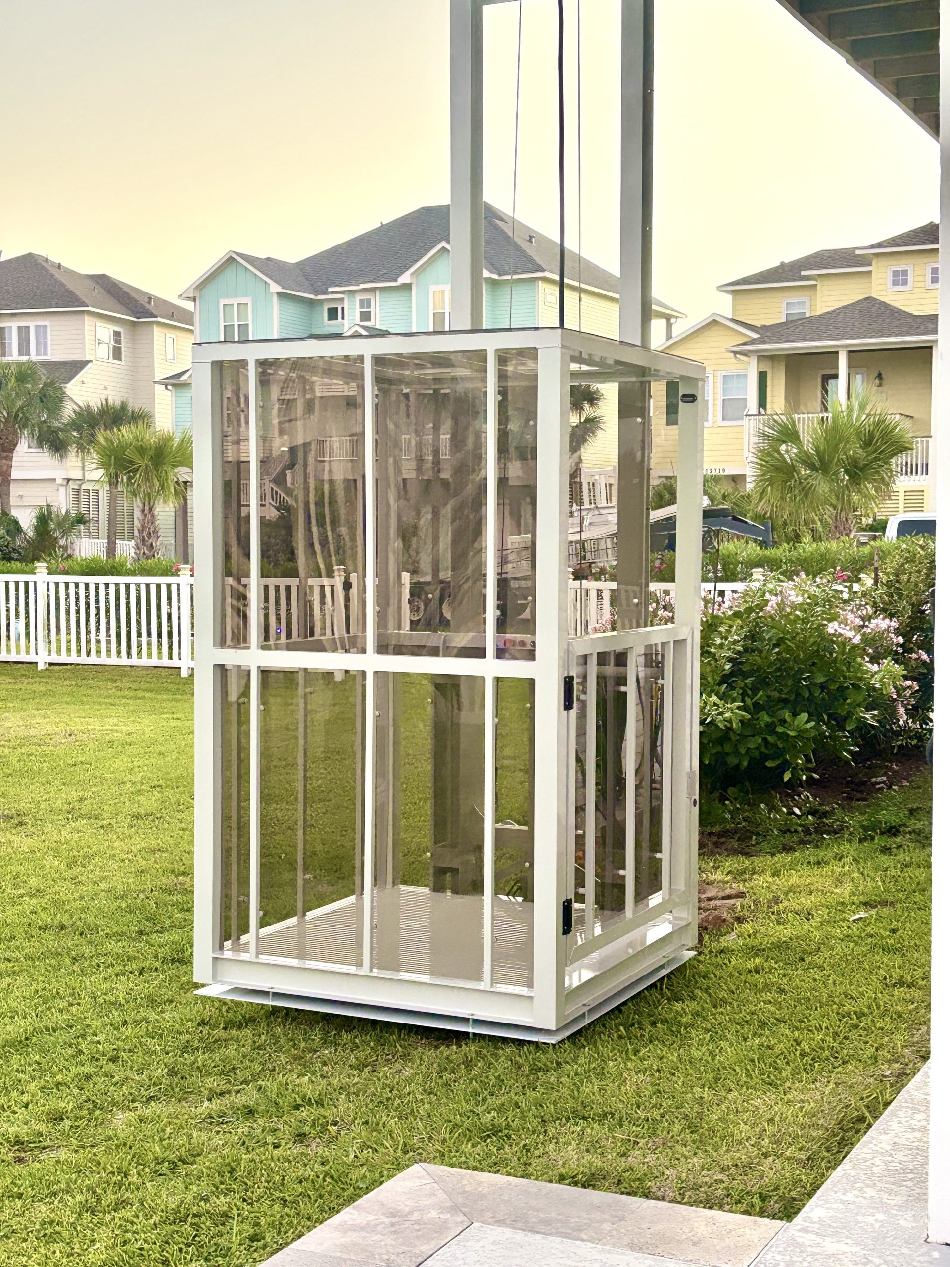 Galaxy Traveler passenger platform lift on a row of pastel beach houses