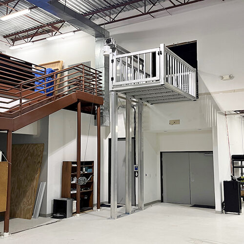 Galaxy Voyager HD cargo lift at a warehouse mezzanine with red steel stairs