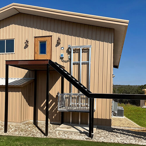 Galaxy Voyager HD heavy-duty cargo lift on a tan metal commercial building exterior