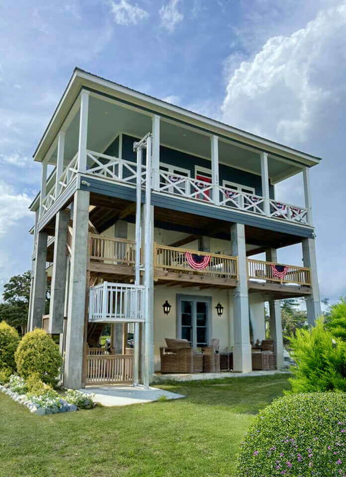 Galaxy Voyager+ cargo lift on a large blue-and-white coastal stilt home